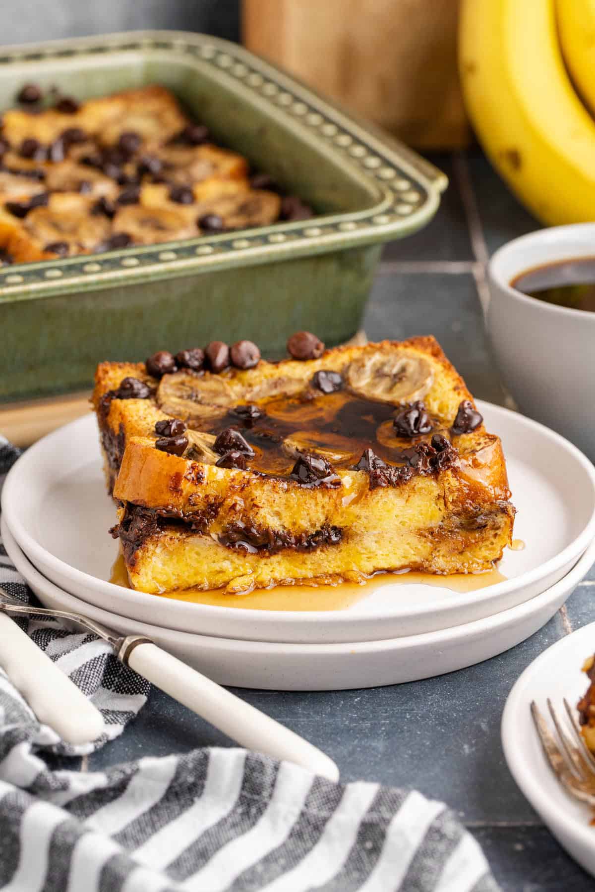 Banana French Toast Casserole on a plate with the dish in the back