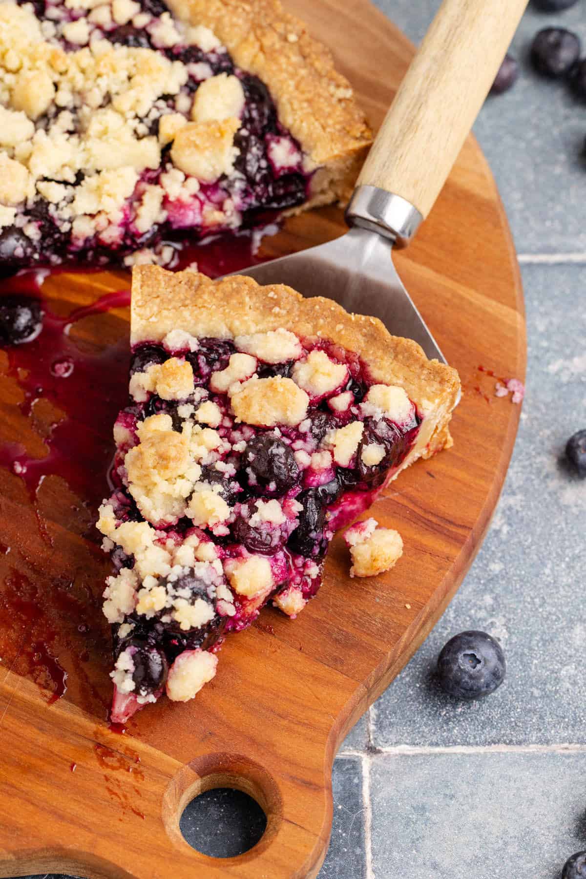 Blueberry Tart slice on a pie server