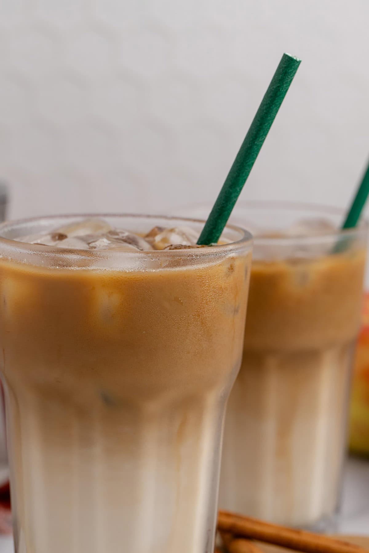 Iced Apple Crisp Oat Milk Macchiato Served Over Ice with a Straw