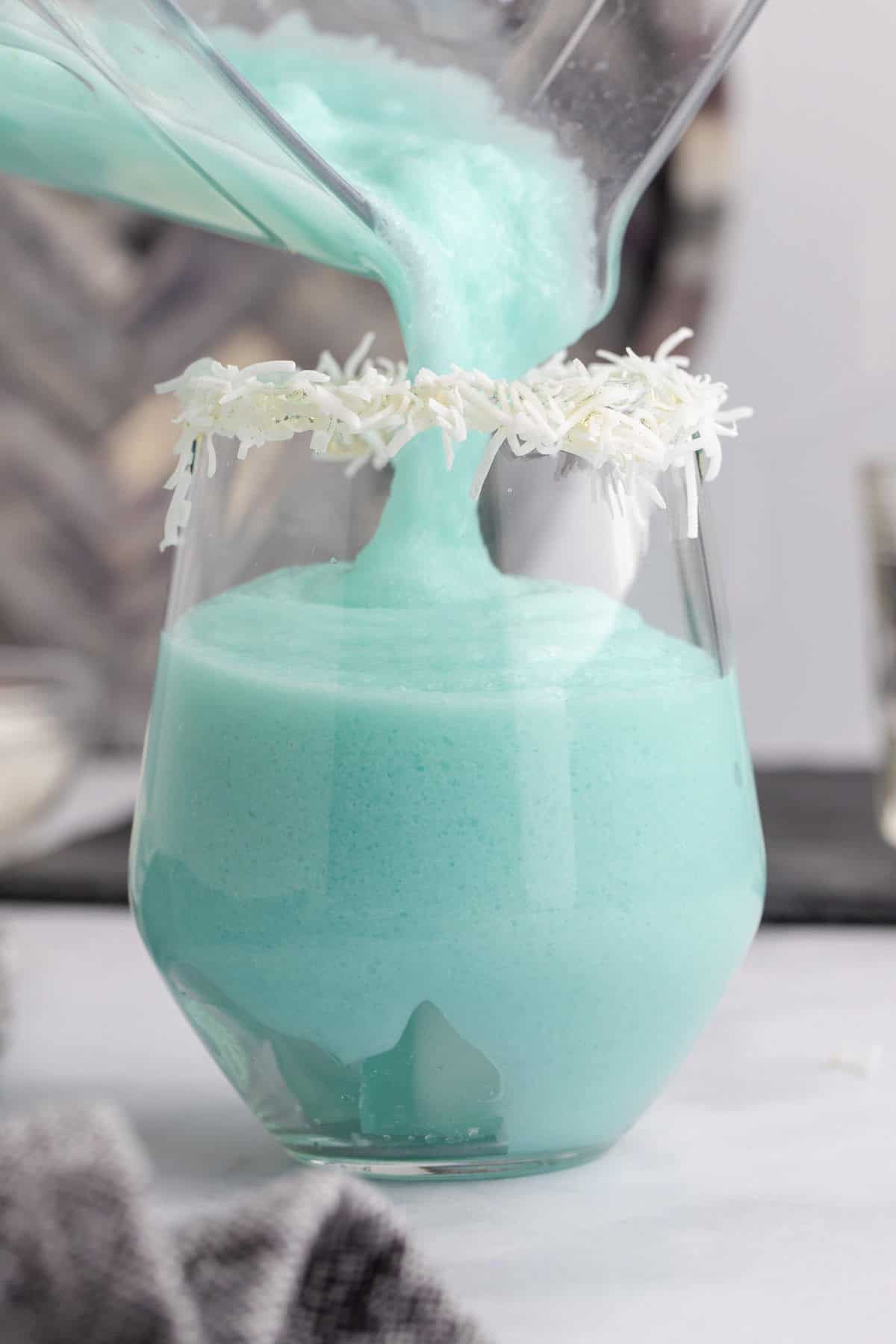 Blue Jack Frost Cocktail Poured into Glass from Mixer