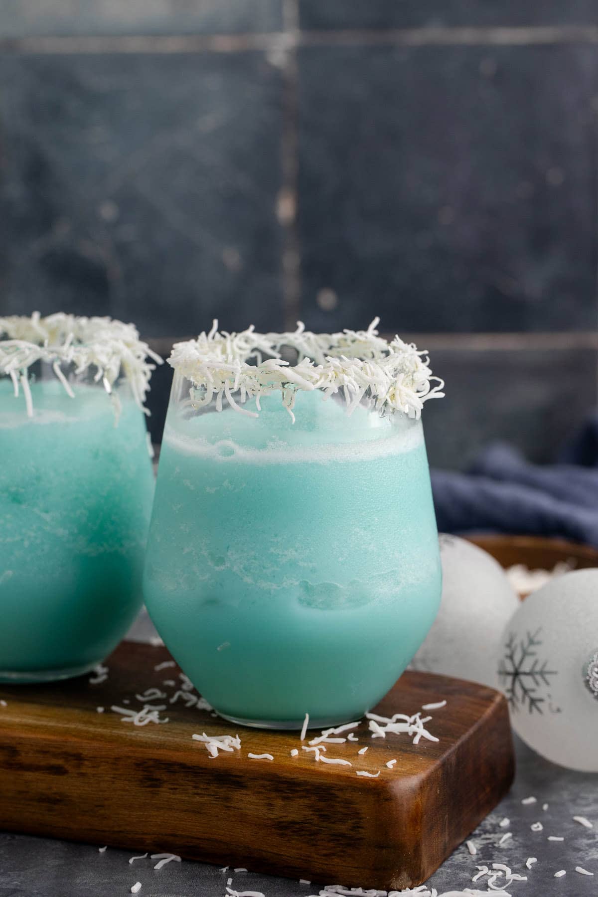 Jack Frost Cocktail in a Clear Glass Garnished with Shredded Coconut Rim