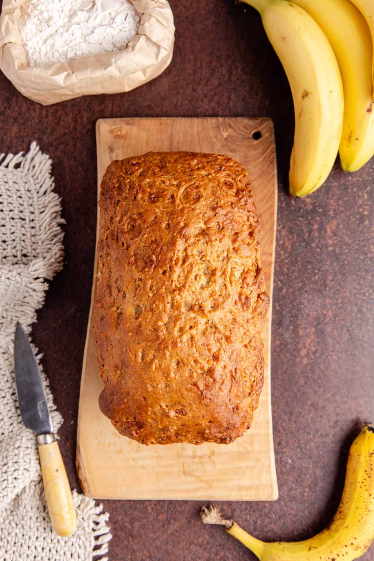 4 Ingredient Banana Bread from above after being baked on a cutting board