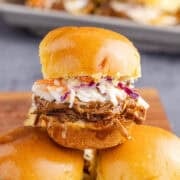 Brisket Sliders stacked on a cutting board close up