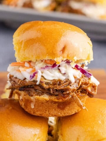 Brisket Sliders stacked on a cutting board close up