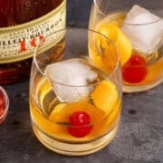 Bulleit Old Fashioned on a tray with a an orange twist and cherry