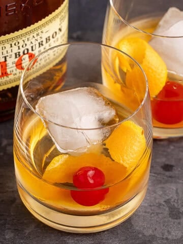 Bulleit Old Fashioned on a tray with a an orange twist and cherry