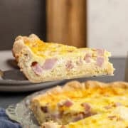Ham and Swiss Quiche Slice Lifted on Pie Server Side View