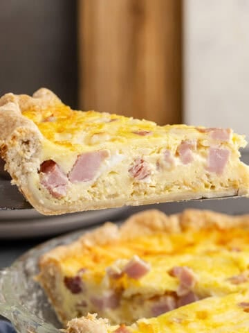 Ham and Swiss Quiche Slice Lifted on Pie Server Side View