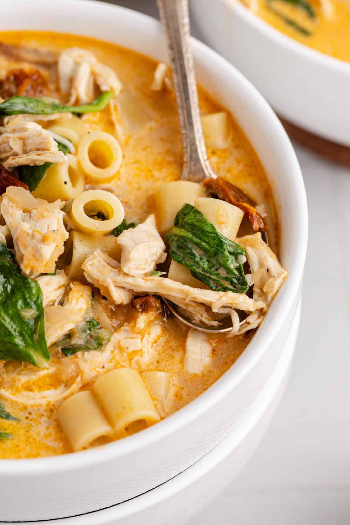 Marry Me Chicken Soup Close Up View in a Bowl Scooped with a Spoon