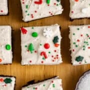 Peppermint Brownies with frosting and sprinkles on a cutting board