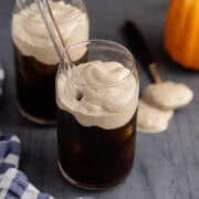 Pumpkin Cold Foam in a glass overtop of iced coffee