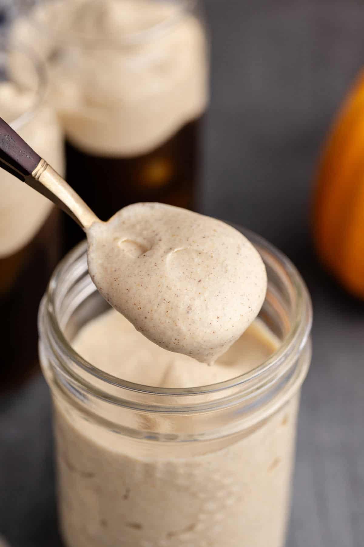 Pumpkin Cold Foam on a Spoon over a mason jar