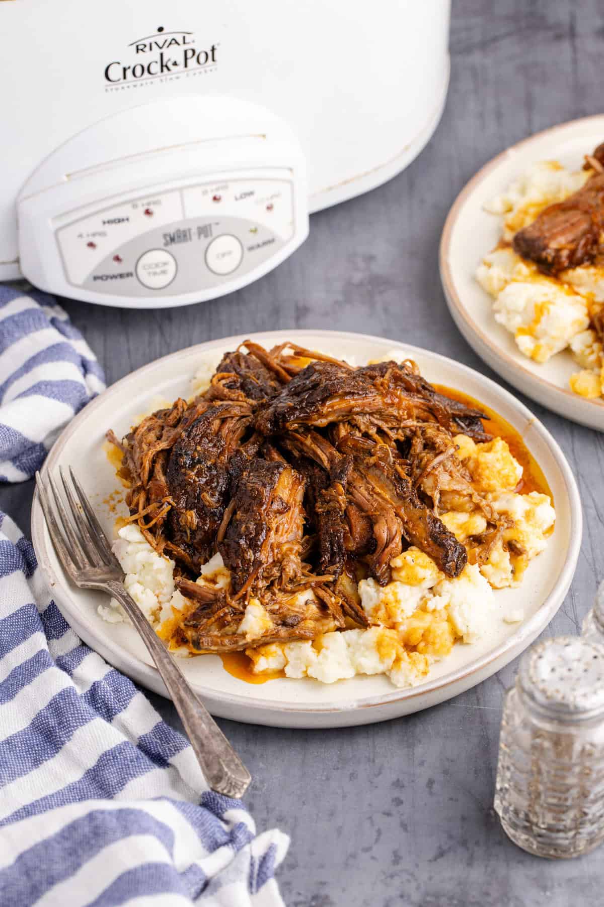 Two plates of Slow Cooker Brisket shredded with potatoes
