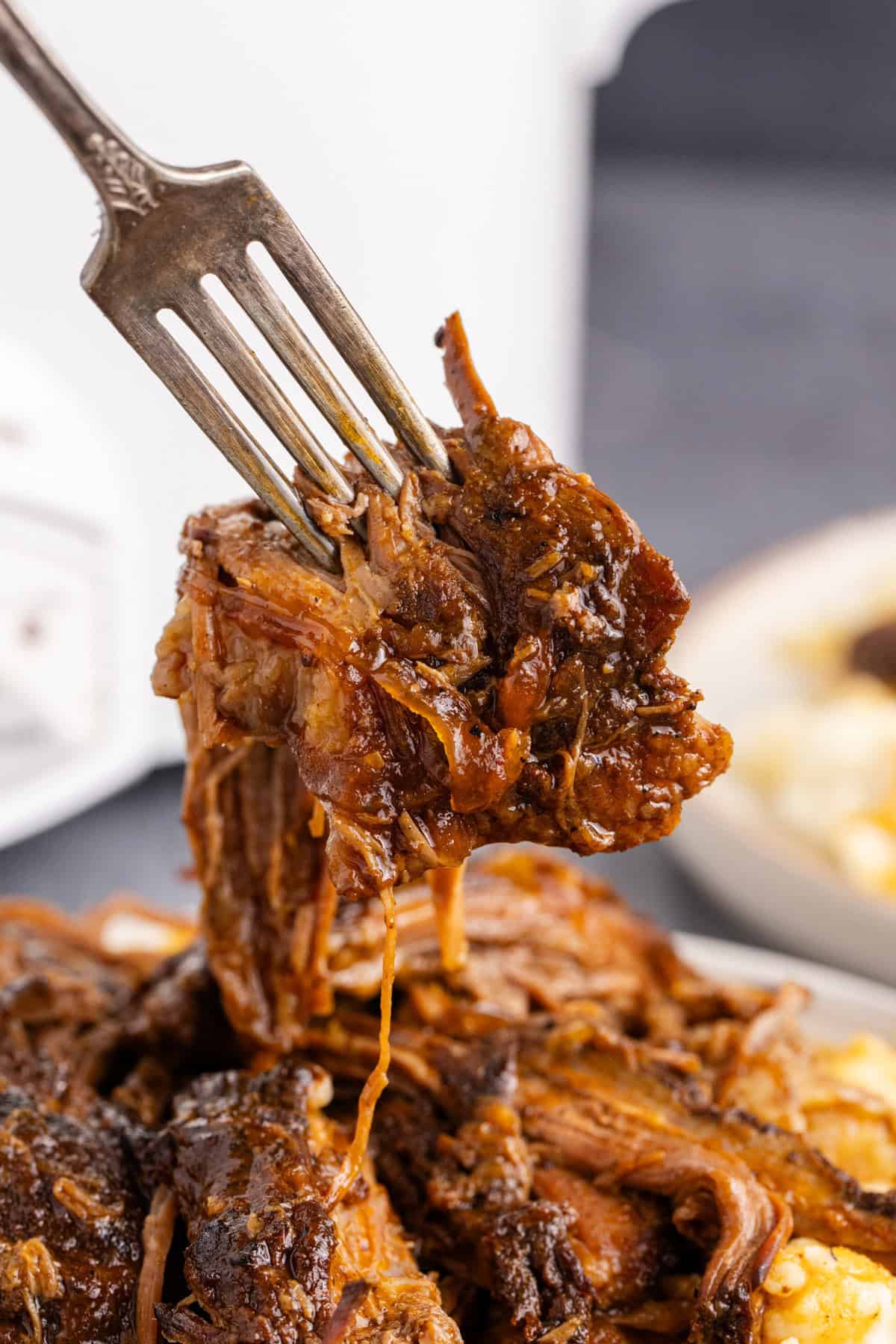 Slow Cooker Brisket shredded on a fork close up