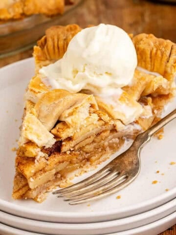 Apple Pie stacked on plates with ice cream on top