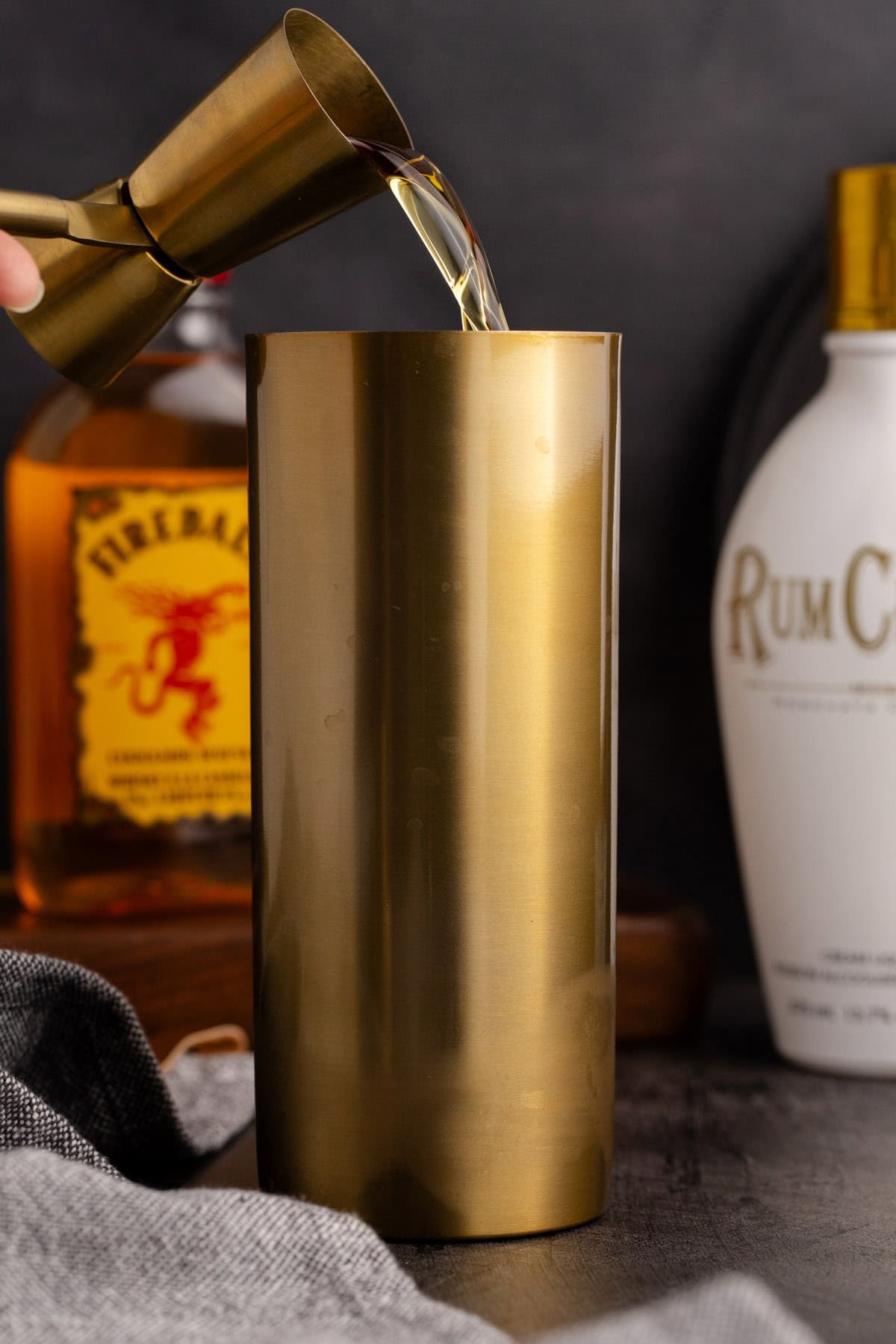 Cinnamon Toast Crunch Shot being made by pouring Fireball in a cocktail shaker