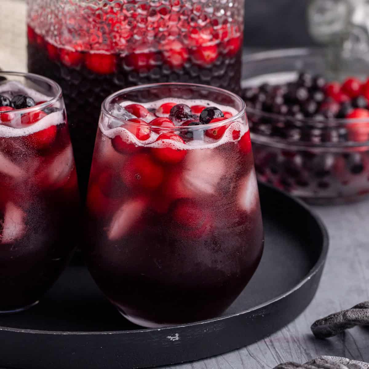 Halloween Sangria in glasses and a pitcher on a tray