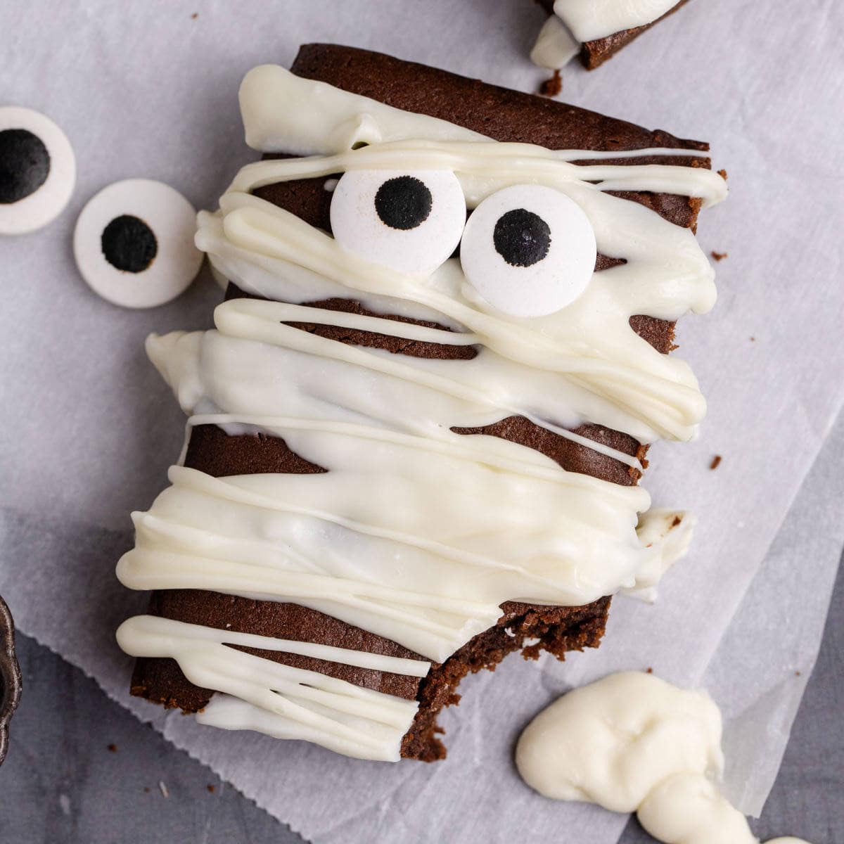 Mummy Brownie with googly eyeballs on parchment paper