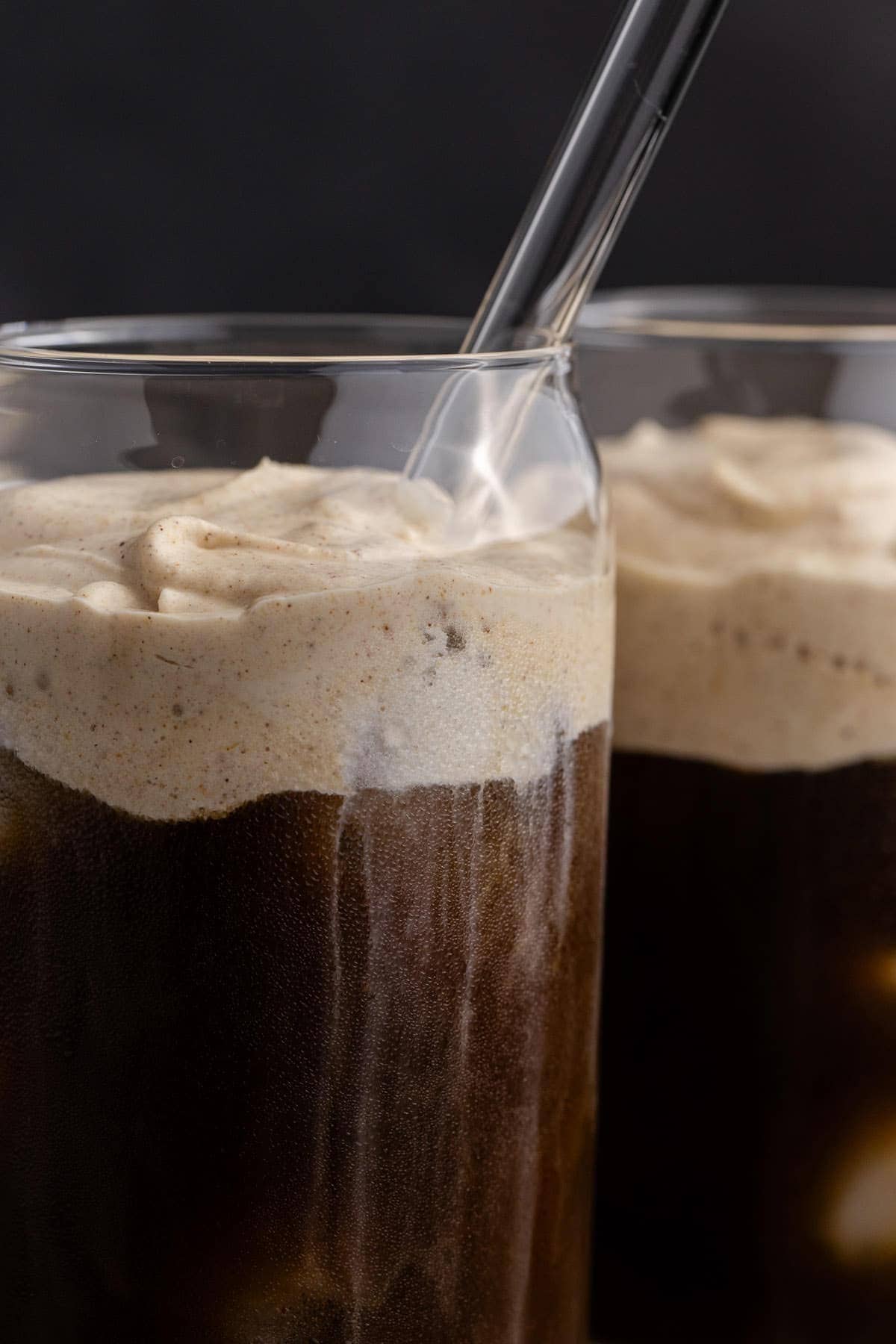 Pumpkin Cold Foam in a clear glass with iced coffee