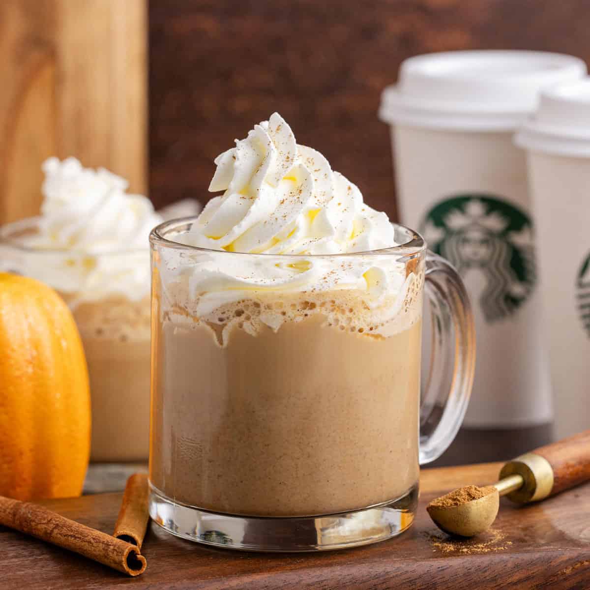 Copycat Pumplin Spice Latte on a cutting board with cups in the background