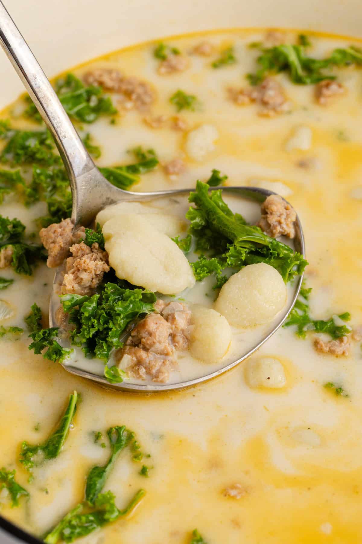 Zuppa Toscana on a ladle in the pot close up