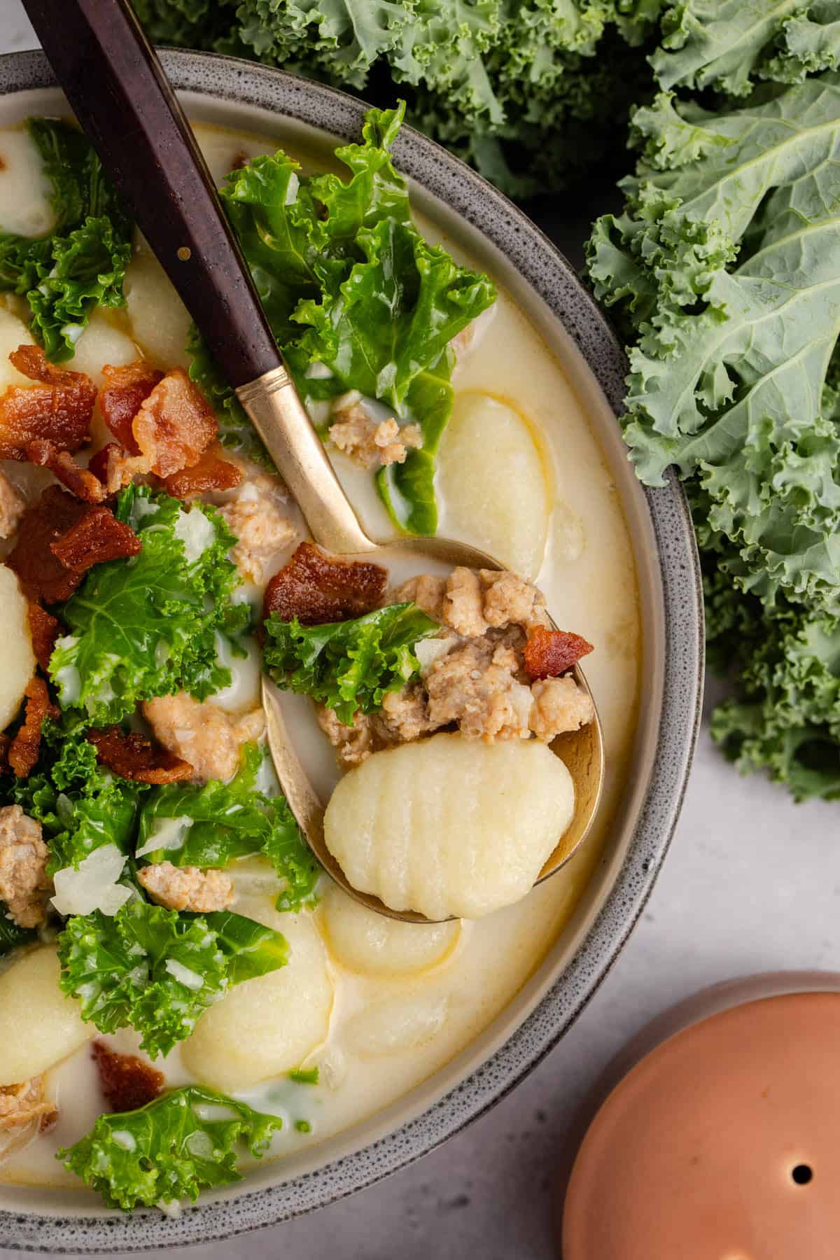 Zuppa Toscana in a bowl with a spoon close up