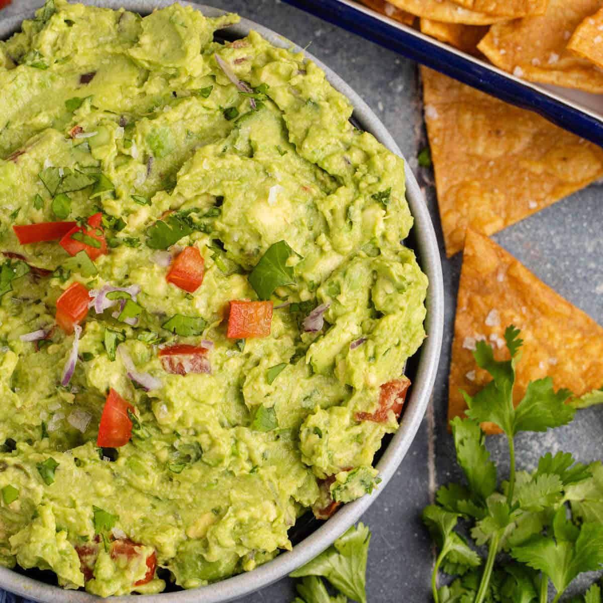 25 Quick and Easy Game Day Appetizers Guac and Chips close up on a counter