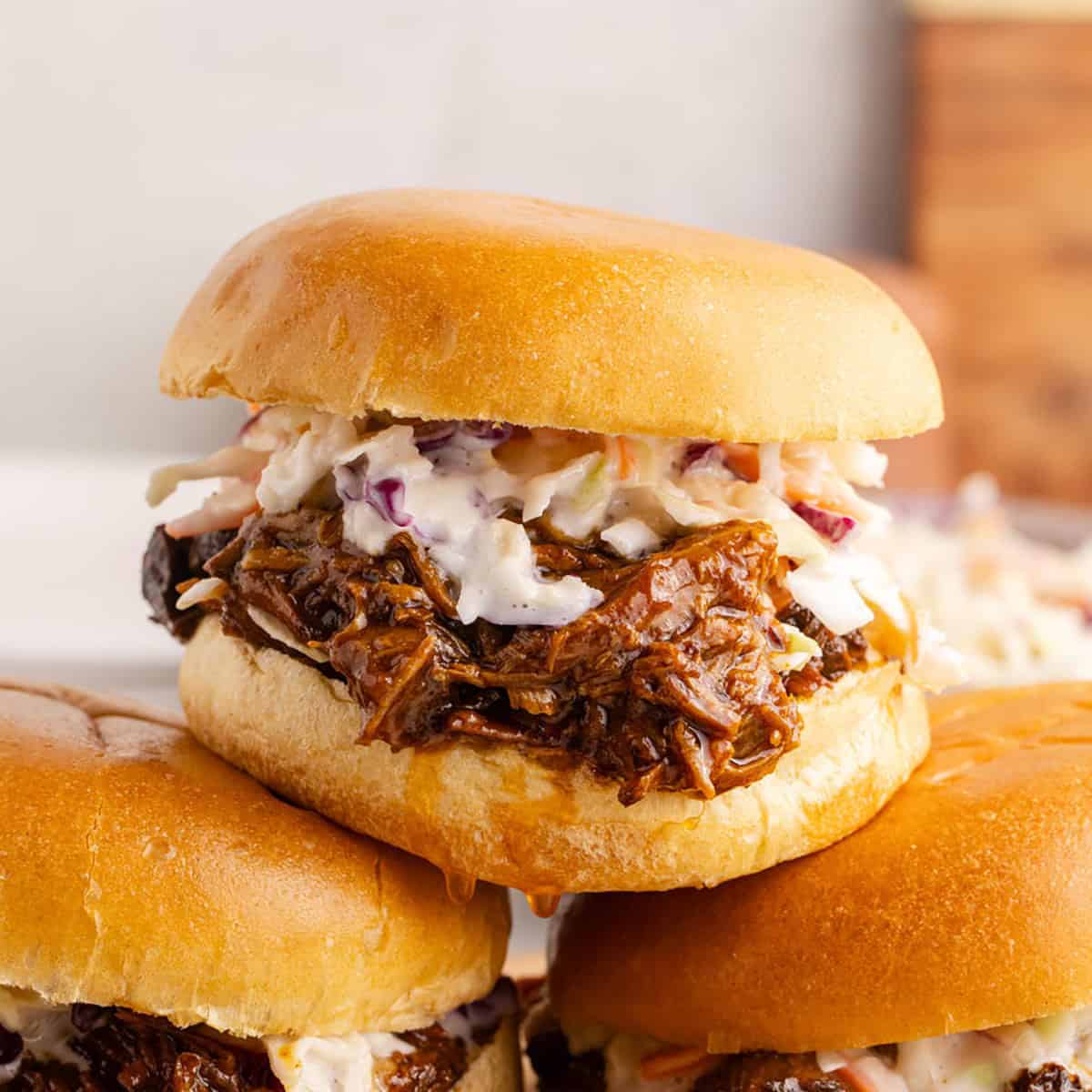25 Quick and Easy Game Day Appetizers BBQ pulled pork sliders stacked on top of each other