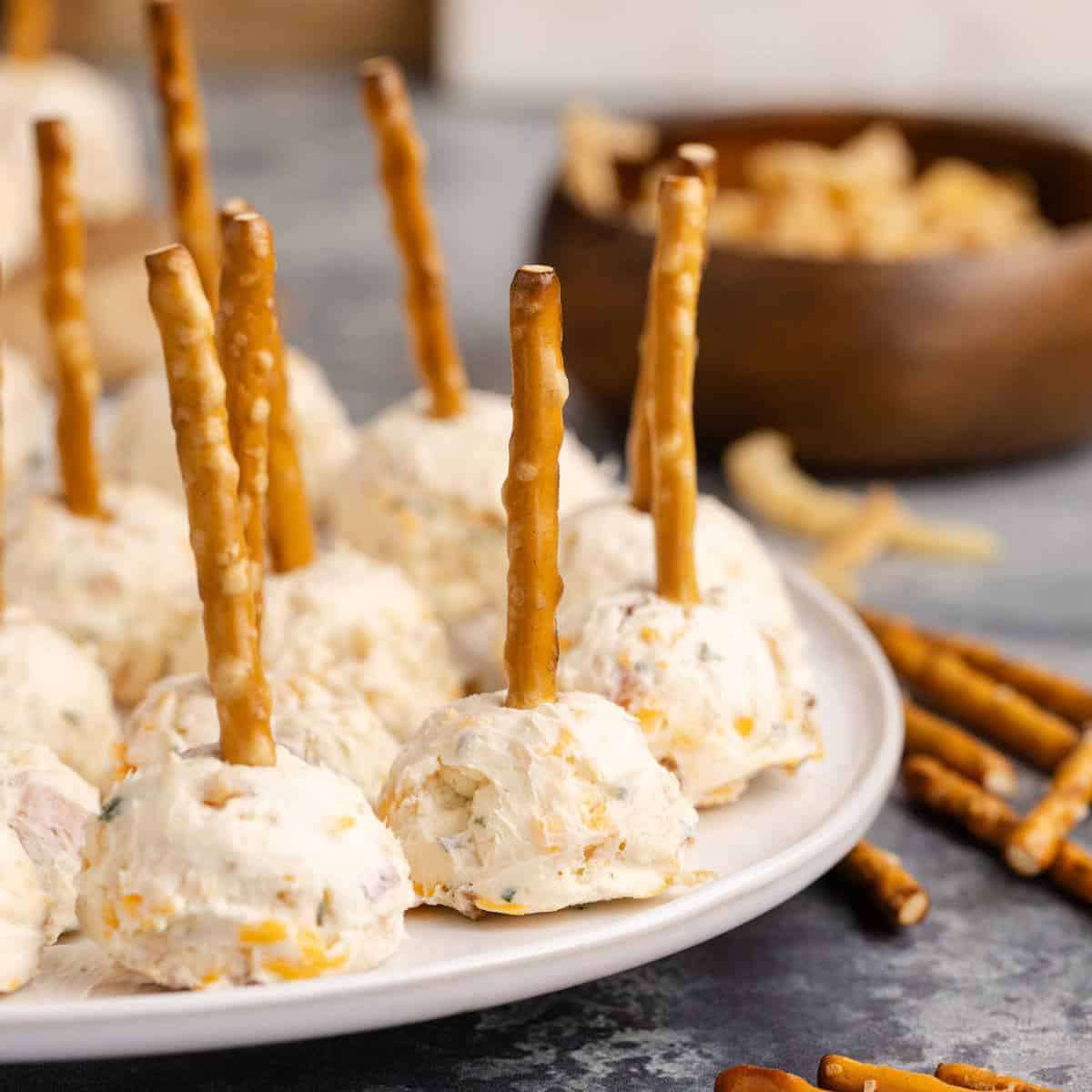 25 Quick and Easy Game Day Appetizers Mini Cheese Balls on a platter with pretzels