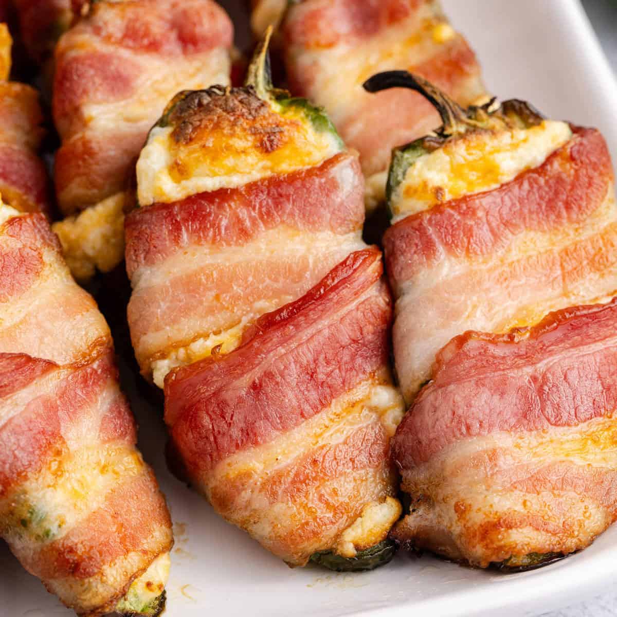 25 Quick and Easy Game Day Appetizers Bacon Wrapped Jalapeños close up on a platter