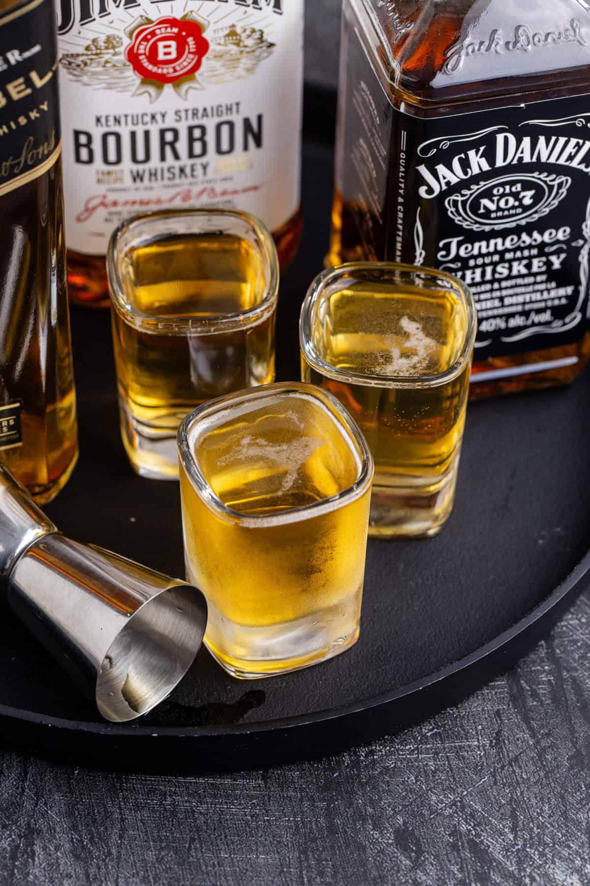 3 Wise Men Shot in Shot Glasses on a Tray with Liquor Bottles