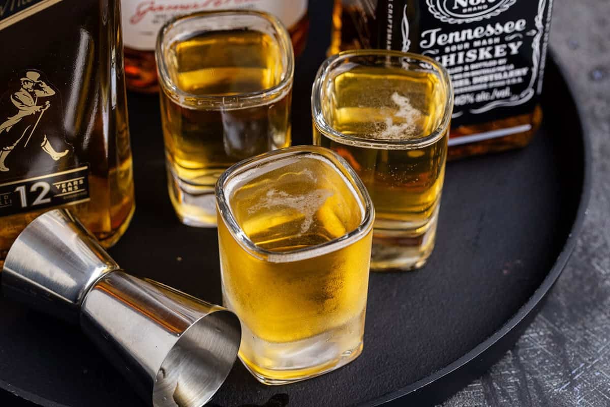 3 Wise Men Shot in Shot Glasses on a Tray with Liquor Bottles