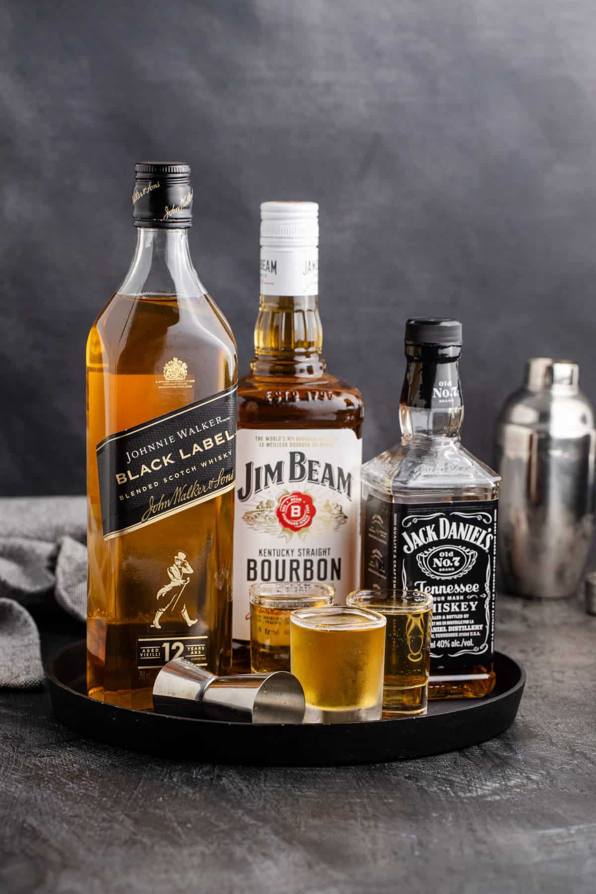 3 Wise Men Shot in Shot Glasses on a Tray with Liquor Bottles