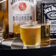3 Wise Men Shot in Shot Glasses on a Tray with Liquor Bottles Close Up