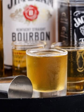 3 Wise Men Shot in Shot Glasses on a Tray with Liquor Bottles Close Up