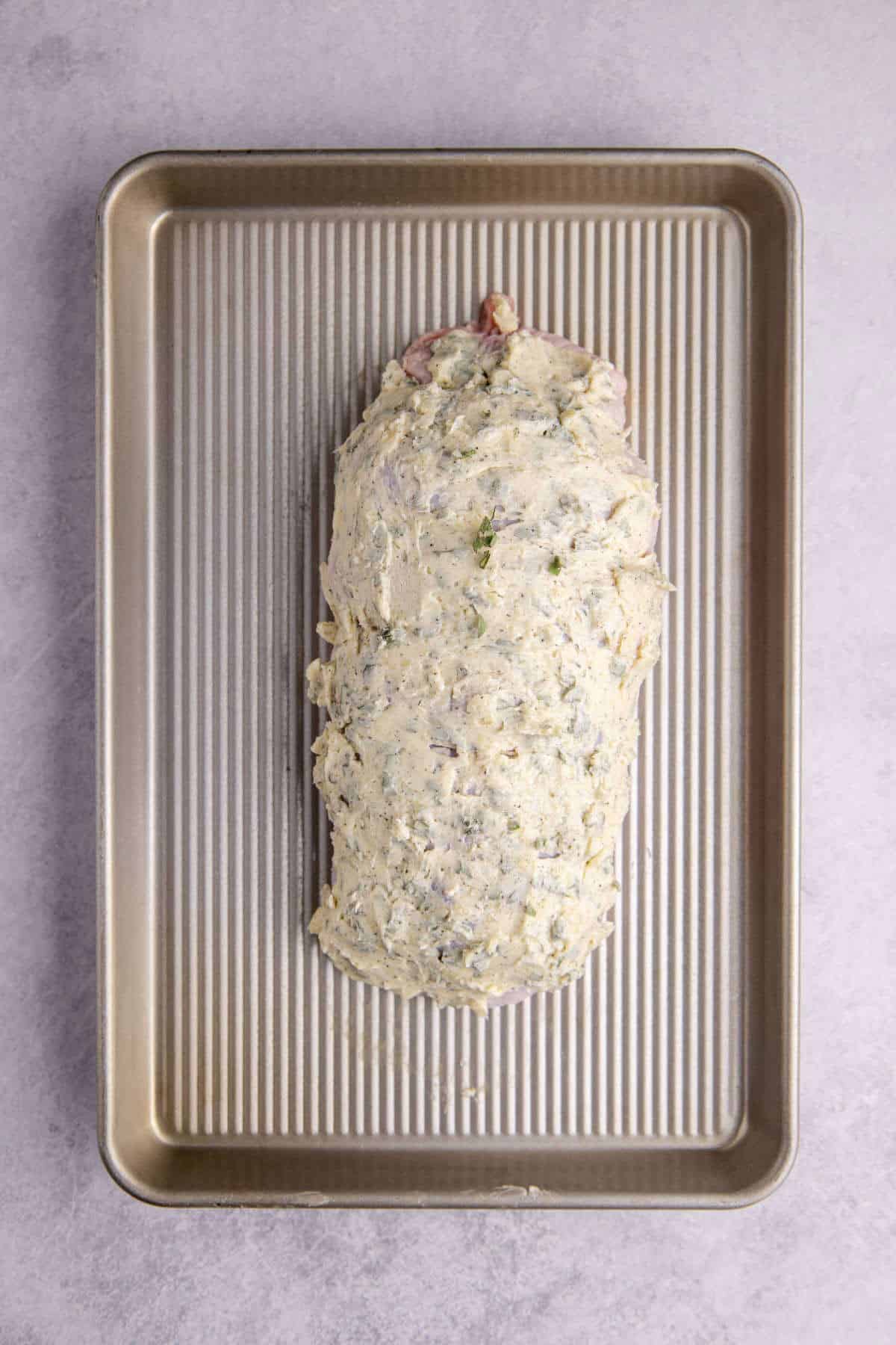 Boneless Turkey Breast on a Baking Pan with Garlic and Herb Butter Spread On