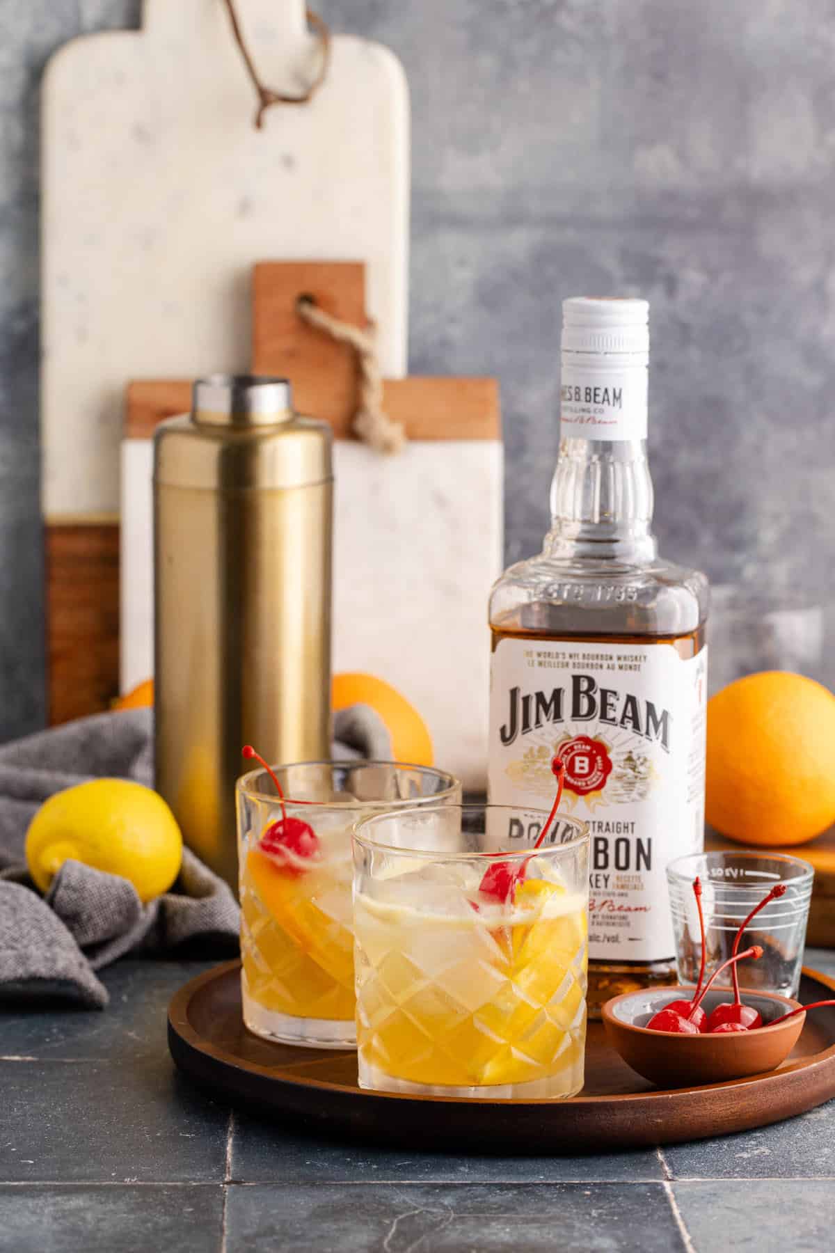 Bourbon Lemon Cocktails in Glasses on a Tray with Maraschino Cherries