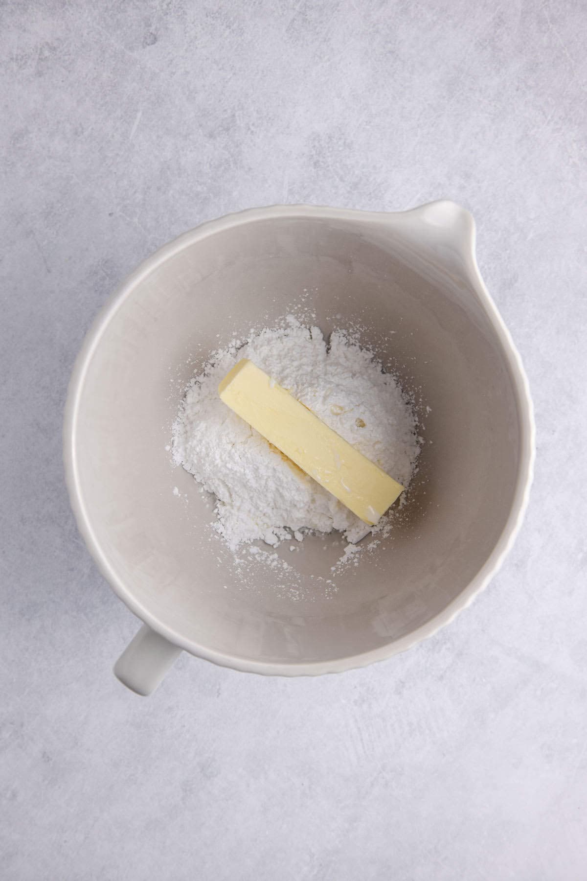 Buttercream Frosting for Sugar Cookies Powdered Sugar and Stick of Butter in Bowl of Stand Mixer