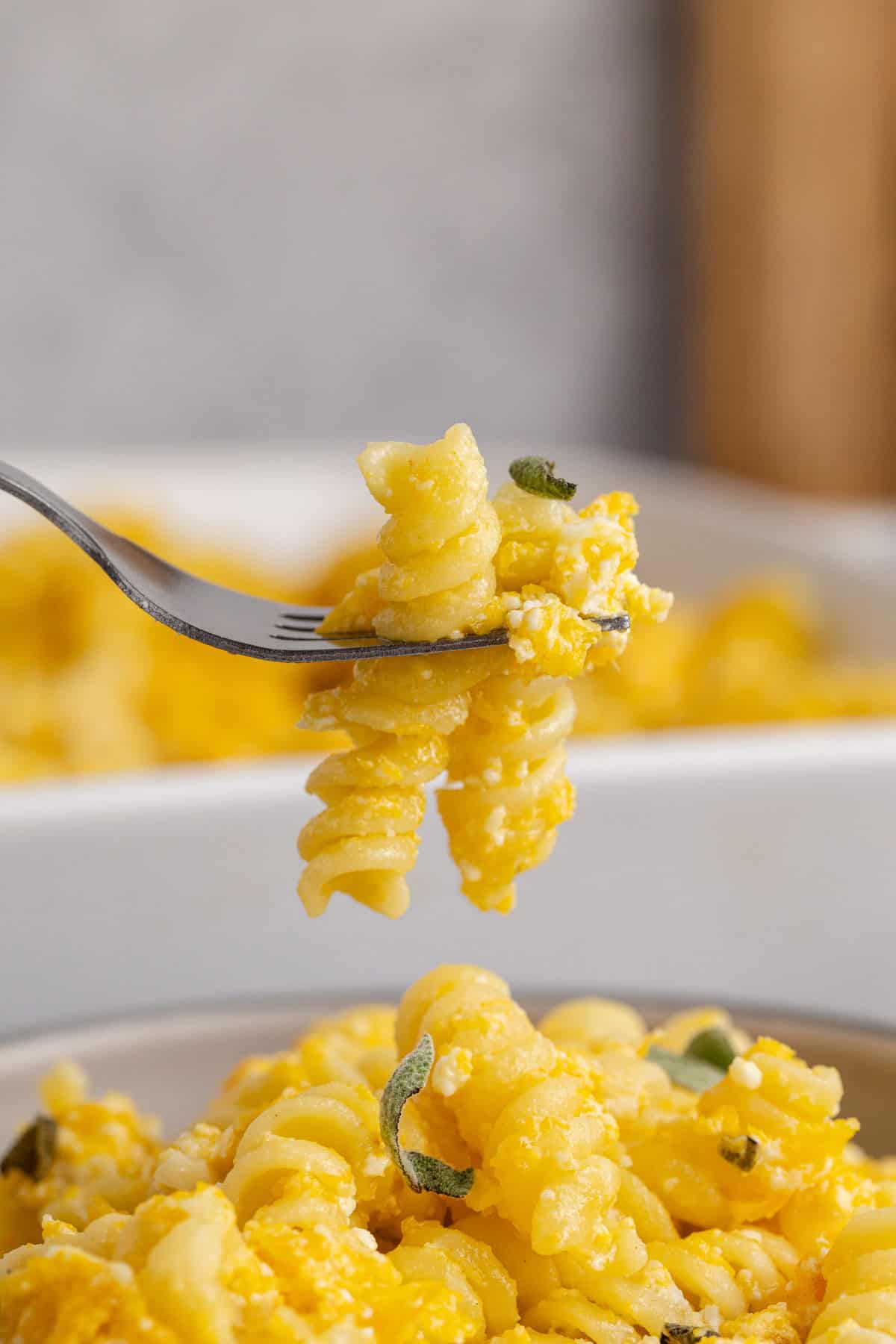 Butternut Squash Feta Pasta on a fork with fresh sage
