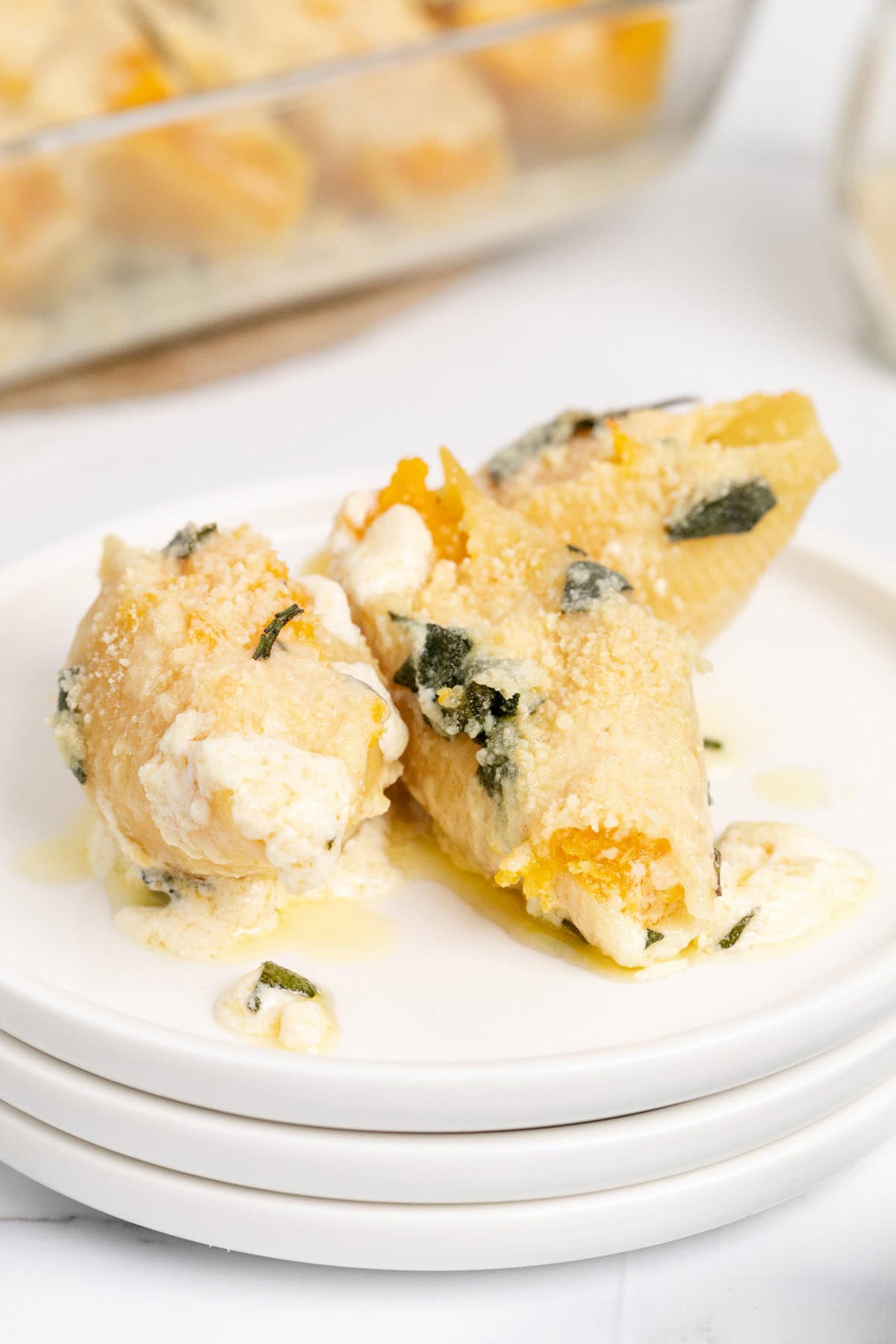 Butternut Squash Stuffed Shells with Creamy Sauce and Parmesan Cheese on a Plate