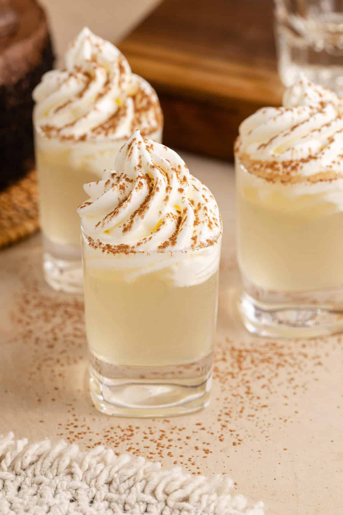 Chocolate Cake Shot in Shot Glasses and Garnished with Whipped Cream and Cocoa Powder
