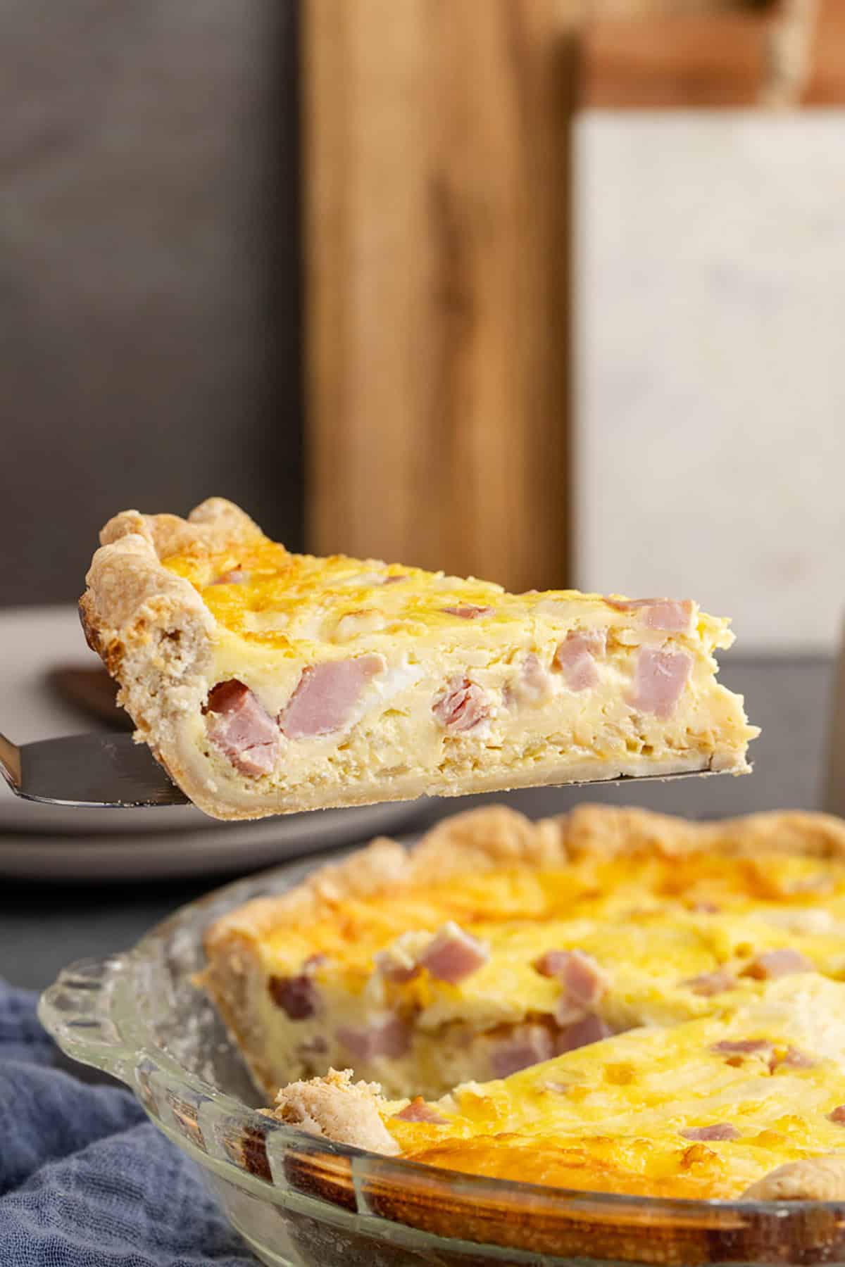 Slice Being Lifted From Ham and Swiss Quiche