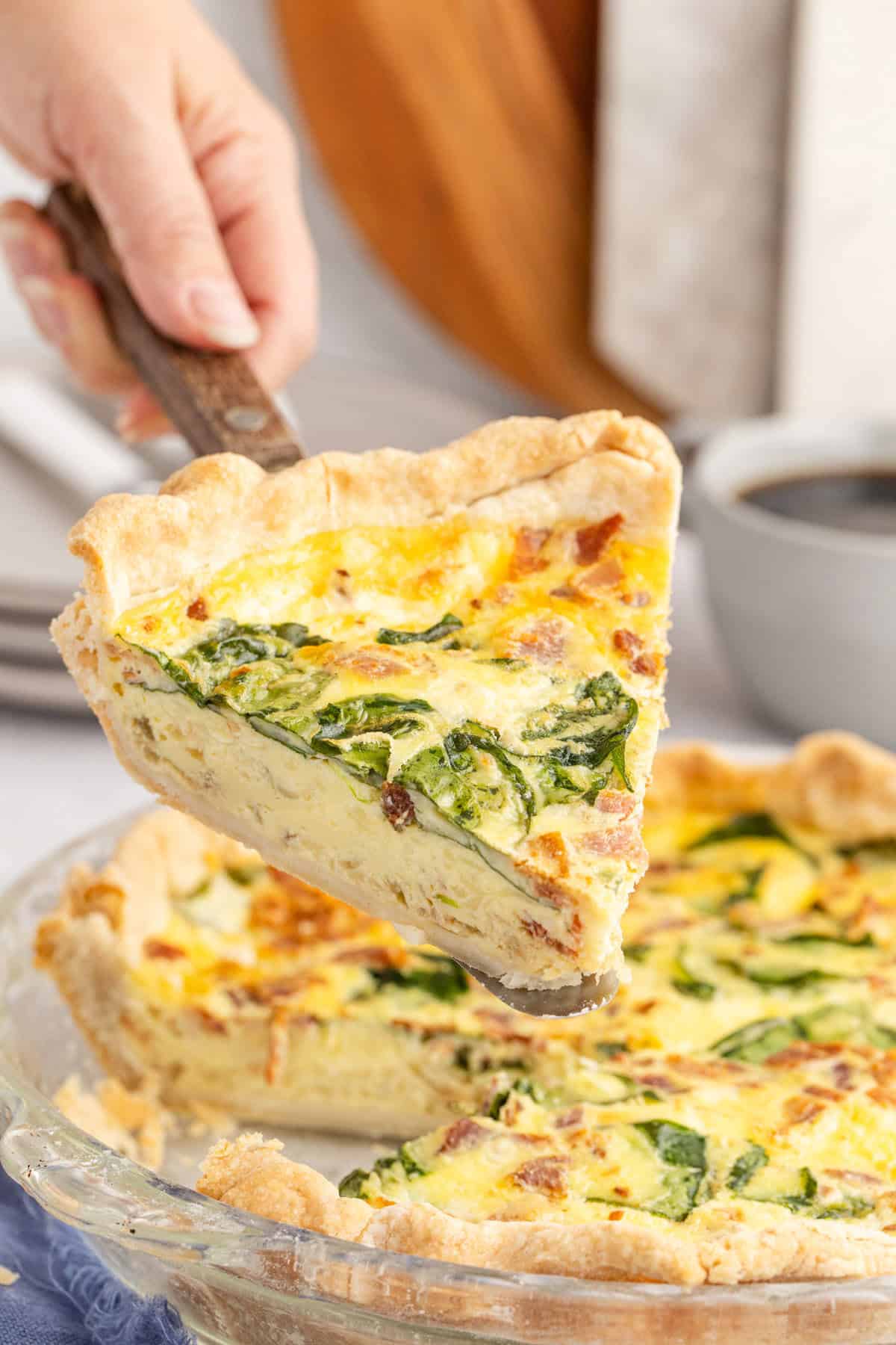 Slice Being Lifted of Spinach Bacon Quiche