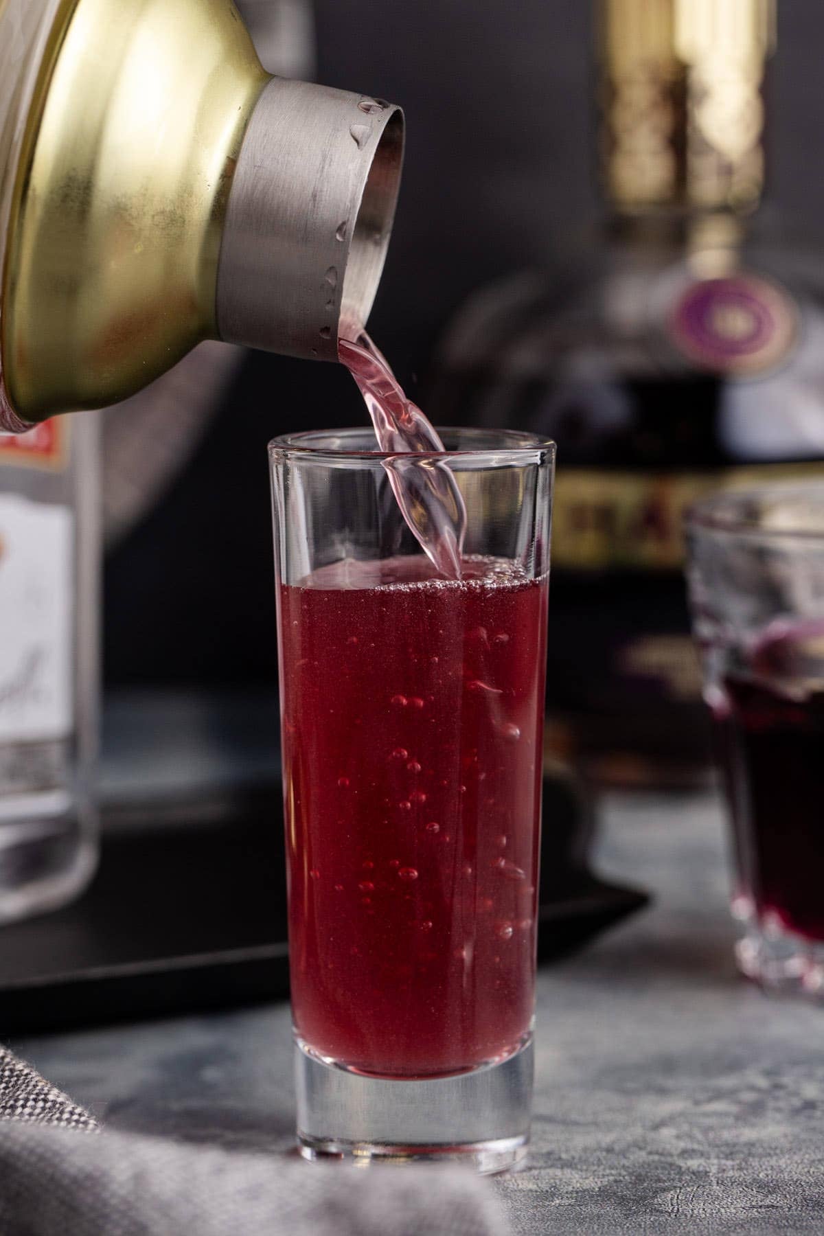 Grape Ape Shot Poured from a Cocktail Shaker into a Tall Shot Glass