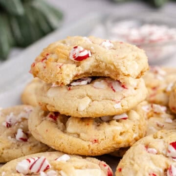 Peppermint Cookies on a backing sheet stacked with a bite taken