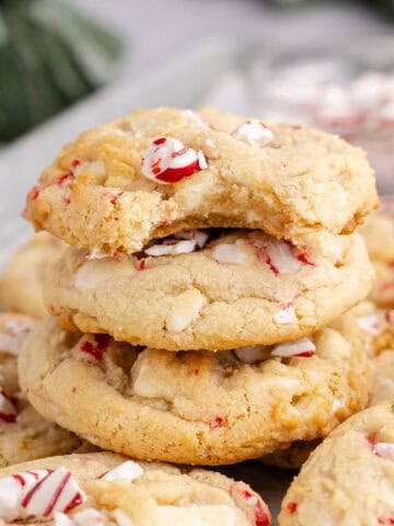 Peppermint Cookies on a backing sheet stacked with a bite taken