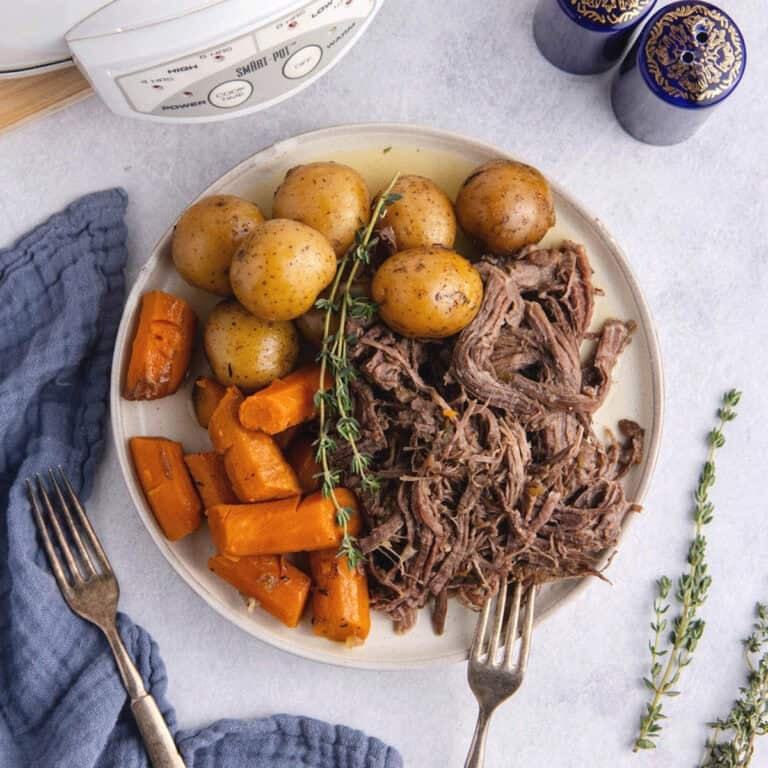 Pot Roast Slow Cooker Recipe all shredded on plate with carrots and potatoes