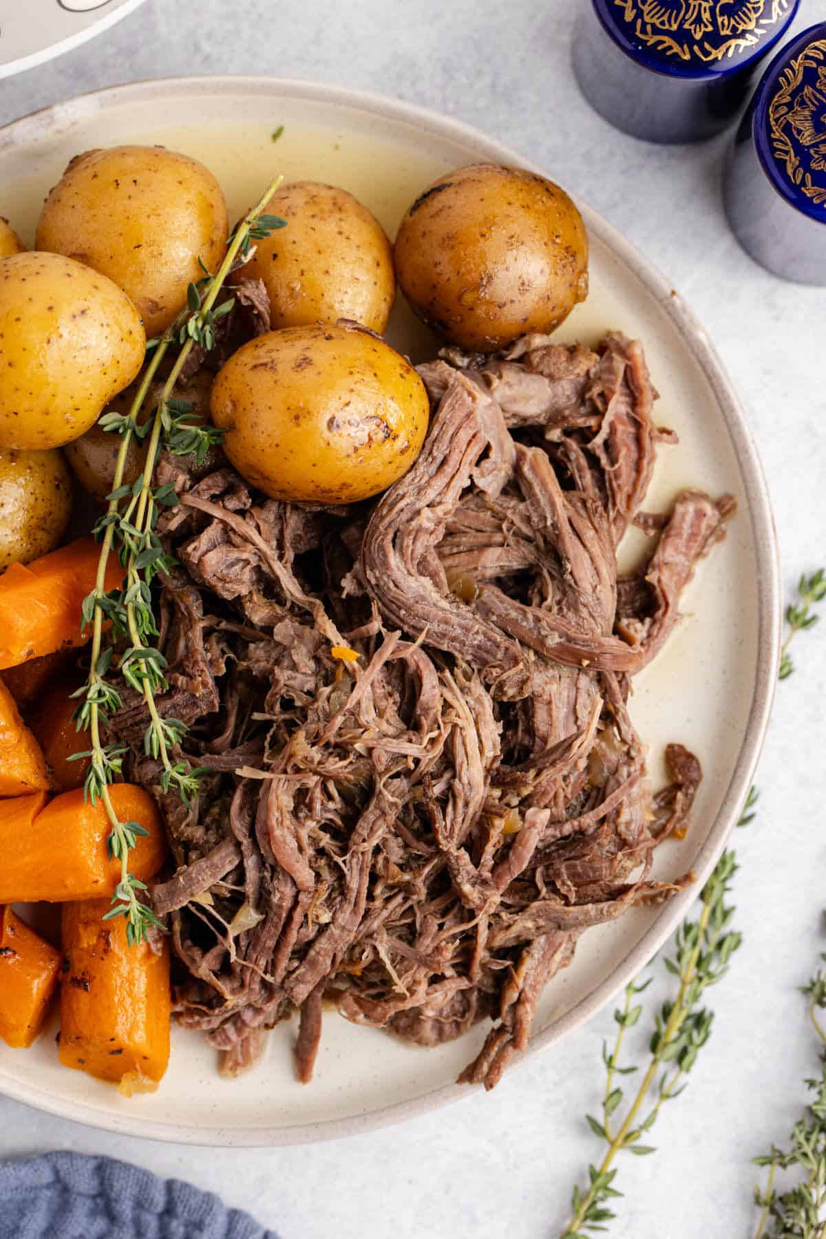 Pot Roast Slow Cooker Recipe all shredded on plate with carrots and potatoes