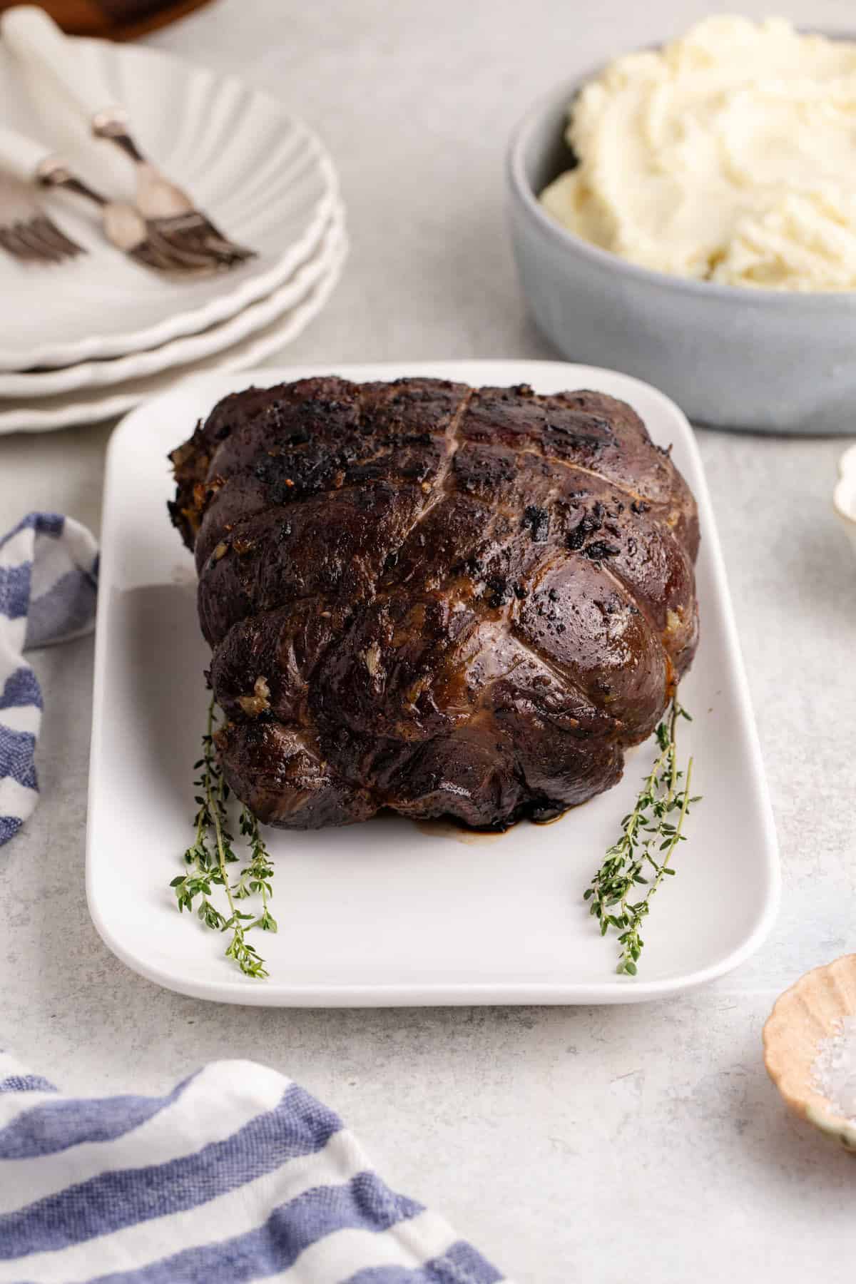 Reverse Sear Beef Tenderloin freshly seared on a platter with fresh thyme