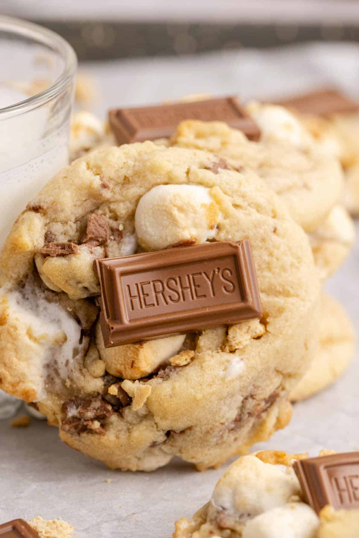 Smores Cookies up close leaning on a glass of milk